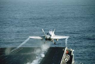 (a) A plane is being launched from an aircraft carrier. (b) During the launch, a catapult accelerates the jet down the flight deck. ( George Hall/Corbis Images)