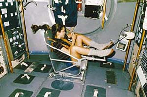 Astronaut Tamara Jernigan uses a body mass measurement device to measure her mass while in orbit. (Courtesy NASA.)